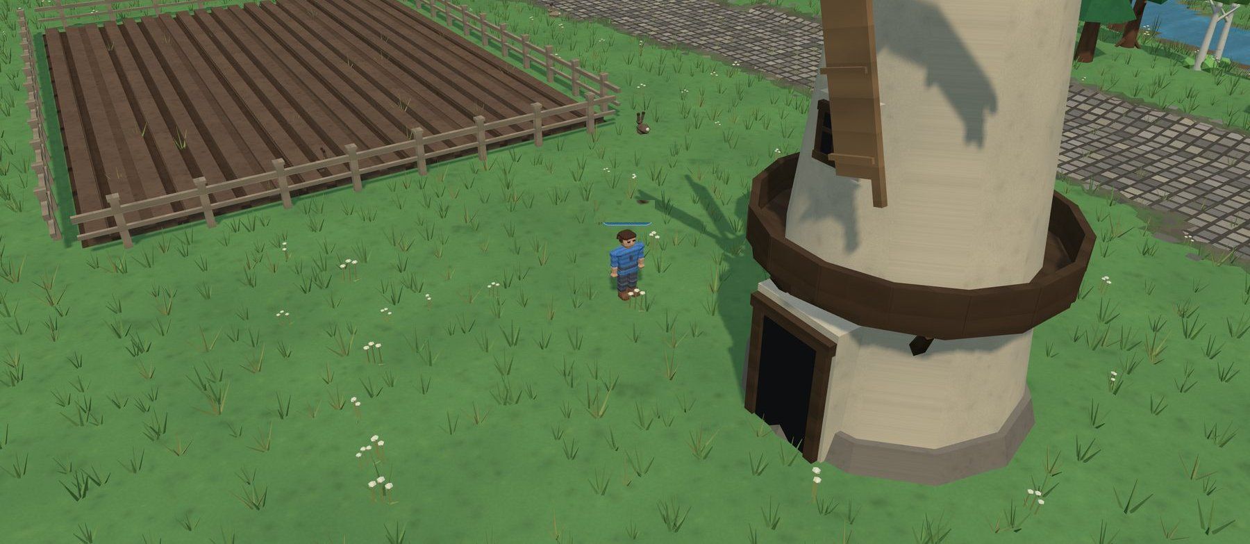 A player standing beside the windmill at the farmstead, with ploughed and wheat fields behind a fence